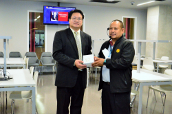 ผู้ช่วยศาสตราจารย์ ดร. บุญญพัฒน์ ชูเกียรติ มอบของที่ระลึกให้กับหอสมุดรัฐสภา โดยมีบรรณารักษ์เป็นตัวแทนรับมอบ
